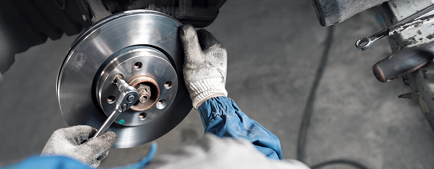 Mechanic Changing A Car Brake Disc